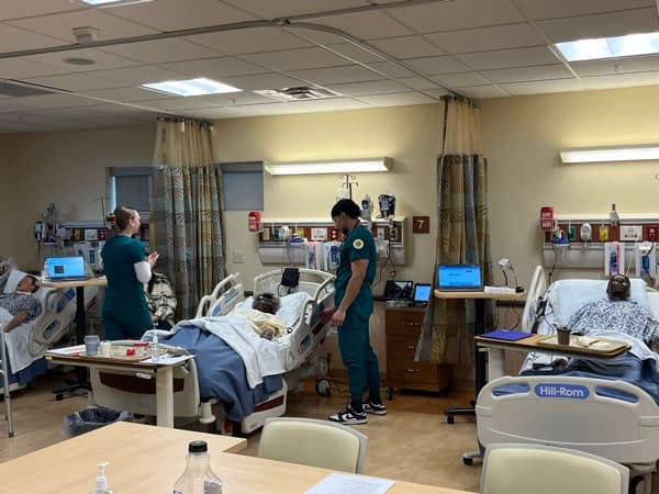 Nursing students managing multiple patients in SimVS Nurse Station simulation at SUNY Brockport